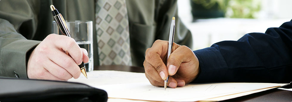 Business professionals signing contract